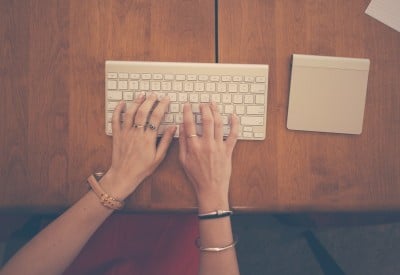 hands-woman-apple-desk-large